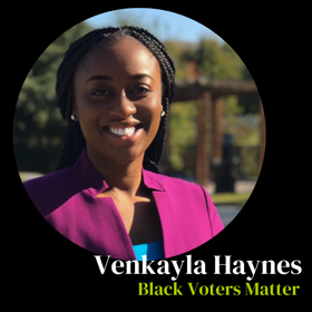 Venkayla Haynes of Black Voters Matter smiles for her headshot wearing a magenta blazer and blue blouse.