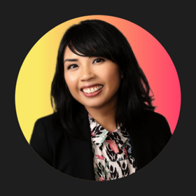 Rachel Reyes smiles wearing a black blazer for her staff headshot.