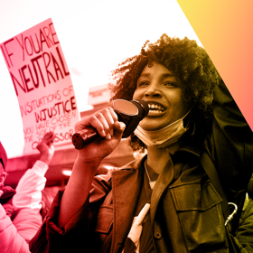 A Black woman leads a protest for Black Lives Matter.