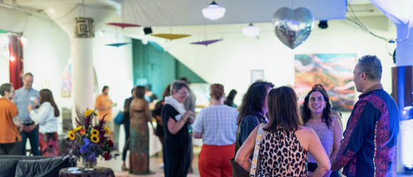 Candid wideshot of people mingling during HFJ's 40th celebration gathering