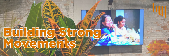 Image of a green and organge plant in front of a TV screen showing a smiling person. Overlayed by bold text "Building Strong Movements"