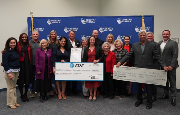 A group of people standing with a check for $50,000 from AT&T to VCCF