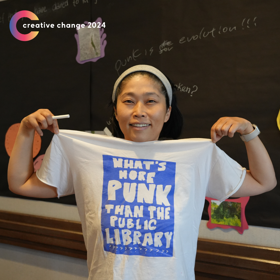 Creative Changer Naoco Wowsugi holding up a punk shirt